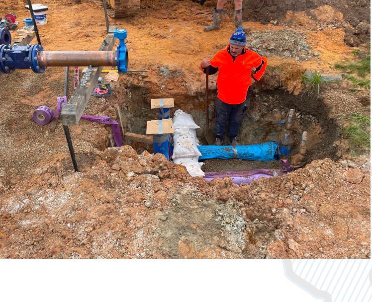Workers installing underground water services